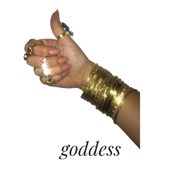 A brown skinned hand wearing gold rings gives the thumbs up sign. The wrist is wearing gold bangles. The word 'godess is underneath'. The background is white.