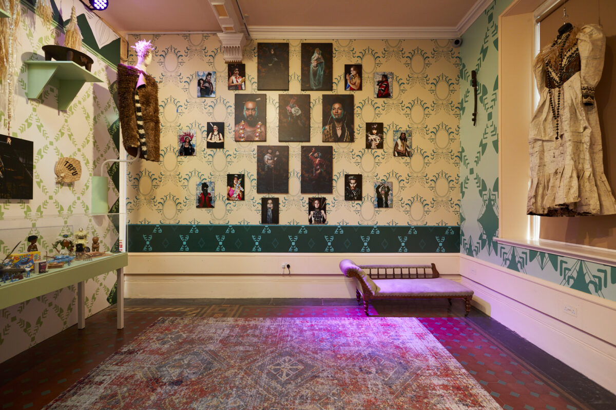 A room filled with objects and portrait photographs on the wall