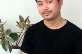 Photo of Clayton Lee wearing a black T-shirt